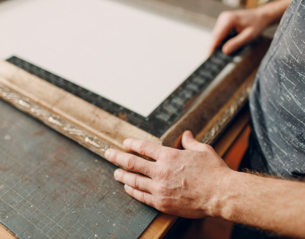 A person crafting a picture frame.